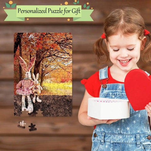 Child smiles holding heart box next to completed puzzle featuring dolls under autumn trees, Six Pack Sublimation Blank Jigsaw Puzzles White A5 Size, 80 Pieces Each, DIY Transfer Friendly for Heat Press Printing and Crafts