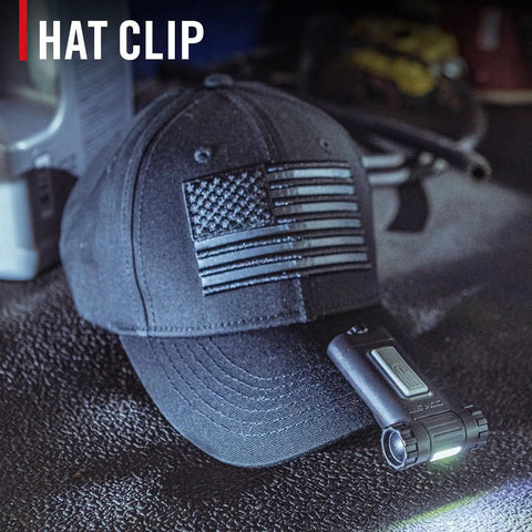 Magnetic LED Clip Light With Dual Color White And Red Beams, 80 Lumen, attached to black cap on workbench