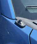 Antenna Delete Cap For Ford F-150, SVT Raptor, And F-150 Lightning EV on blue truck with rubber seal and textured finish