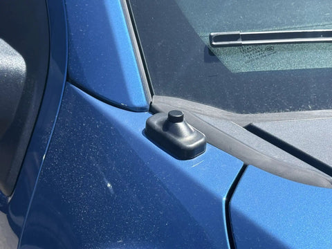 Antenna Delete Cap For Ford F-150, SVT Raptor, And F-150 Lightning EV on blue truck with rubber seal and textured finish