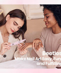 Two women using HEMA Free Pink Gel Nail Kit With UV Light Travel Set 5 Piece for a home manicure on a beige sofa.