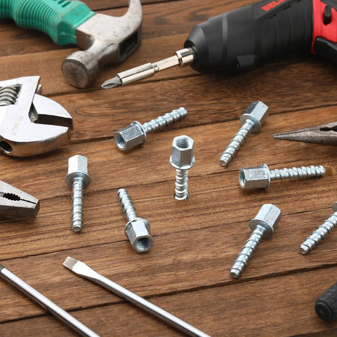 100 Piece Heavy Duty Zinc Steel Concrete Anchors, 3/8 Inch Threaded Rod With 1/4 Inch Diameter And 1-1/2 Inch Length screws and tools on wood surface.