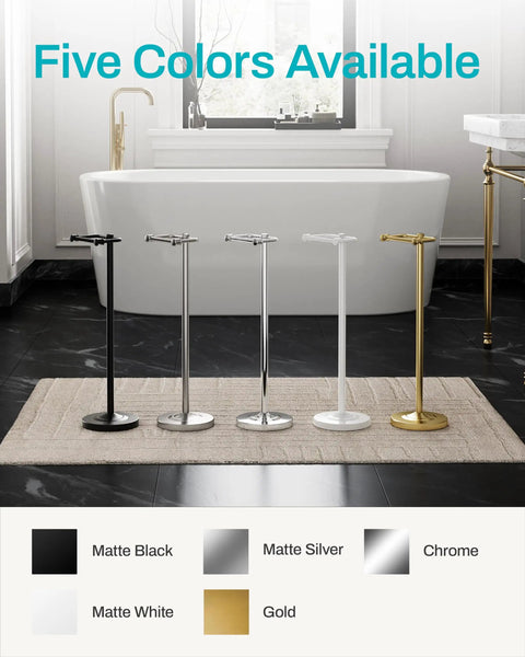 Heavy Duty Freestanding Toilet Paper Holder Stand In Matte Gold Frame standing among black, silver, white, and gold colors in a bathroom.
