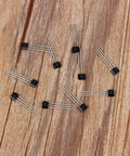 Hall Effect Switches Pack Of 10 A3144 Magnetic Hall Sensor, 3-pin SIP inline detectors on wooden surface