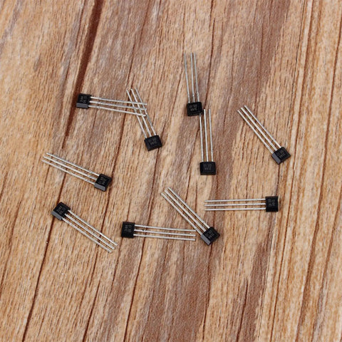 Hall Effect Switches Pack Of 10 A3144 Magnetic Hall Sensor, 3-pin SIP inline detectors on wooden surface