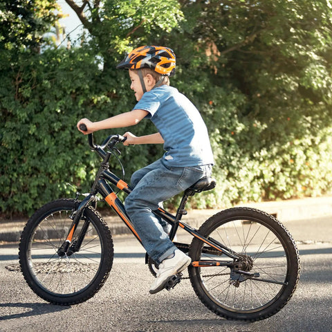 Child riding a bike equipped with Two Pack 20 Inch Heavy Duty Bicycle Tubes With TR4A-40L Schrader Valve Fits 20 X 1.75 1.90 1.95 2.0 2.125 2.25 Tires 45/57-406 Durable Inner Tubes For Mountain And City Rides on a sunny day.