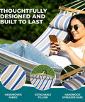 Caribbean Hammock With Pillow For Easy Chill Sessions 48 Inch Wide Poolside Patio Backyard Relaxer Includes Straps And Chains Eco Friendly Polyester And Cotton Blend 265 Pound Capacity Nautical Stripe featuring a person lounging.