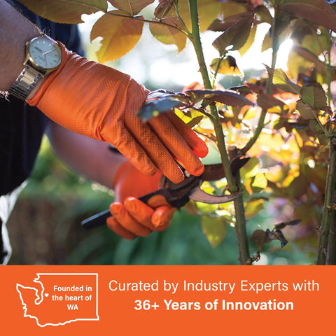 Orange disposable gloves with textured raised diamond grip worn by gardener using pruning shears in close-up