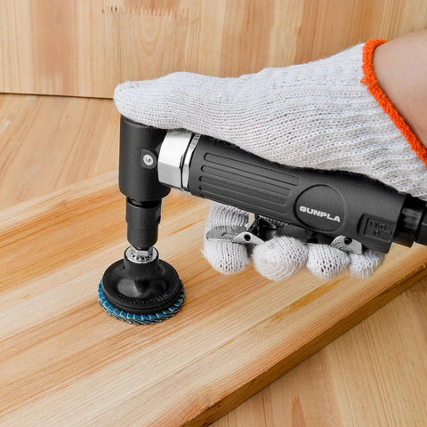 Side view of Gunpla 1/4 in angle air die grinder (90°) operated by gloved hand, blue sanding disc on wood.