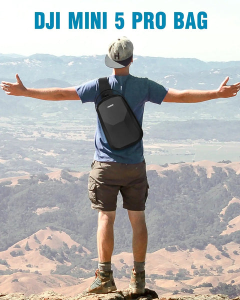Hiker wearing On The Go Mini 5 Pro Case For DJI Drone And RC 2 Controller, seen from the back, standing on a mountain overlook.