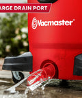 Heavy Duty 12 Gal Wet Dry Shop Vac With Beastly 5.5 Peak HP Motor And Nine Must Have Cleaning Attachments For Cranking Nasty Garage Jobs And Spills Features Classic Red Plastic Design showing large drain port with water flowing.