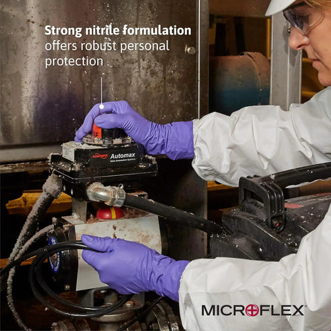 User in heavy duty disposable nitrile exam gloves adjusts equipment, showcasing latex-free and powder-free violet large gloves.