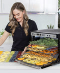 Premium Heavy Duty Digital Food Dehydrator Featuring Stainless Steel Rack Trays And Whisper Quiet Airflow System For Rapid Jerky Fruit Vegetable Nut Drying with fresh fruits and vegetables being dried.