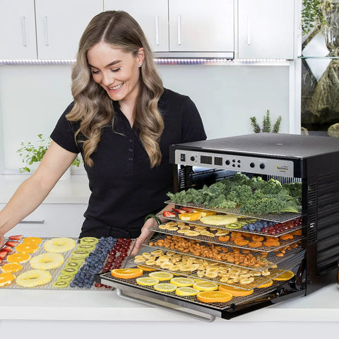 Premium Heavy Duty Digital Food Dehydrator Featuring Stainless Steel Rack Trays And Whisper Quiet Airflow System For Rapid Jerky Fruit Vegetable Nut Drying with fresh fruits and vegetables being dried.