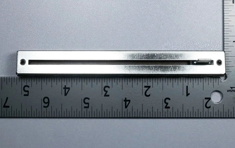 10K Ohm Slide Potentiometer With 100mm Travel, Single Linear Taper, Carbon Metal Housing, 15mm Lever next to ruler