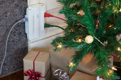 Six Outlet Swivel Power Strip With Two USB Ports, Space Saving Wall Tap Surge Protector Up To 2100 Joules in use by a decorated Christmas tree