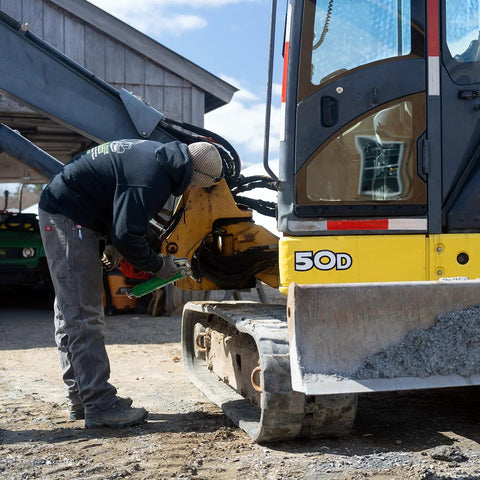 Person using Heavy Duty Pistol Grip Grease Gun With Patented LockNLube Coupler Locks On And Does Not Leak, 20 Inch Hose