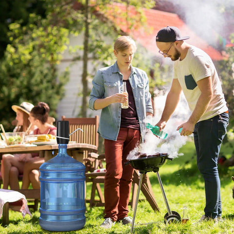 Outdoor scene with a Two Pack Electric Portable Five Gallon Water Dispenser With Micro USB Charging Water Bottle Pump next to a grill.