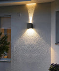 4 Pack Outdoor Indoor LED Wall Lights Sconces IP65 Waterproof Square Aluminum Up And Down Lighting Sleek Black 12W 3000K Warm White 1020 Lumens Wall Lamp For Exterior And Interior Use mounted on exterior wall displaying warm uplight and downlight effect
