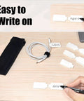 80 Pack Cable Labels and Cord Ties Kit With Write-On Wire Labels, Snap Ties, dual-tip marker in use on desk