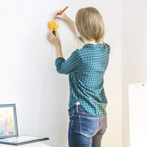 Person using Stud Finder Wall Scanner For Wood And Metal Detection With Light Indicator And Audio Alarm Four Level Flash Light