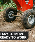 Ultra Duty 7 HP Gas Powered Wood Chipper Shredder Mulcher with reinforced wheels on dirt, easy to move