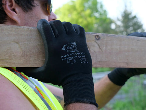 Worker wearing PUG17 Lightweight Polyurethane Dipped Work Gloves With Anti Static And Dope Grip for Bare Hand Sensitivity holding a beam