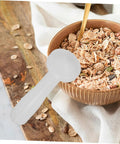 Plastic Espresso Tamper For Home And Commercial Coffee Making No Frills Durable Press Tool next to a bowl of cereal on a table