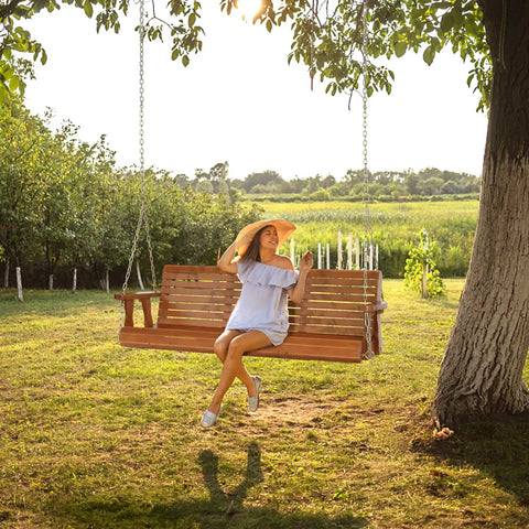 Woman sitting on Built Tough Outdoor Wooden Porch Swing With Adjustable Chains 880 Lb Capacity 5 Ft Brown Garden Bench Seat