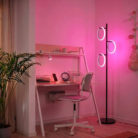 RGB Color Changing Floor Lamp With Tall Tree Design, Modern Standing Lamp For Living Room, Bedroom And Office, 3 LED Lights, Matte Black Finish, Smooth RGB Gradient For Reading, Ambience And Vibe illuminating a pink-lit workspace.
