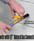 Hands connecting 1/2" natural gas hose to Tri-Fuel Portable Generator With Remote Electric Start, Transfer Switch Ready