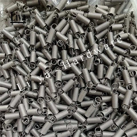 Ten Pack Stainless Steel Tension Springs With Hooks Multiple Sizes For Heavy Duty Auto And Industrial Projects That Provide Serious Support To Your Toolkit Essentials laid out in a pile.