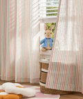 Candy Stripe Linen Curtains For Kids Room Two Panels 96 Inch Length Kid Friendly Grommet Window Treatments Light Filtering Nursery Drapes With Multicolor Stripes Soft Linen Blend hanging in a children's room with a toy rabbit.