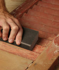Hand using coarse 80-grit sanding sponge 2.5x5x1 inch pack of 2 flexible sponges for contours and flat surfaces on wood