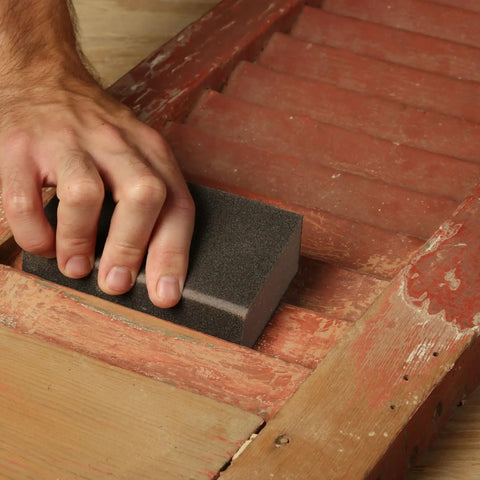 Hand using coarse 80-grit sanding sponge 2.5x5x1 inch pack of 2 flexible sponges for contours and flat surfaces on wood