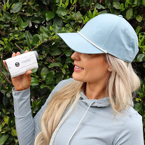 Woman using Vpro Golf Rangefinder With Pinsensor And Flag Lock, 900 Yards Slope Laser, 6X Magnification, outdoors