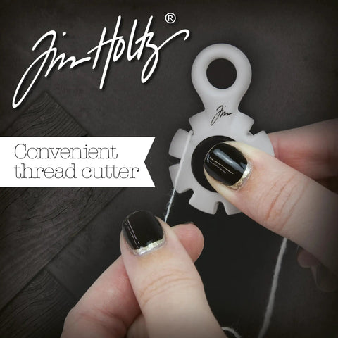 Hands using paper distressing tool with 7 recessed blades for scrapbooking, creating rough torn edges and vintage texture on cardstock.