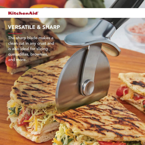 Pizza Cutter Roller Wheel With Sharp Blade For Crusts And Pies slicing quesadillas on a wooden board.