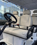 Rock Solid 6 Seater Electric Golf Cart With 48V Lithium Battery And 14 Inch Off Road Tires White interior seating with plush gray upholstery.