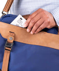 Person placing Notebook Screen Cleaning Wipes For Electronics, Non Abrasive Premoistened Wipes into a blue and tan bag.