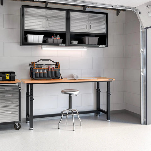 UltraHD Heavy Duty Workbench Table With Solid Wood Top 1000 Lbs Capacity Ideal Garage Workshop And Warehouse Desk Graphite Finish 72 W 25 D 28.5 To 42 H Adjustable Height in garage setting with tool organizer and stool.