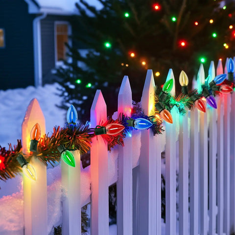 Colorful string lights on snowy white fence, resembling 50Ft Outdoor String Lights With 27 Shatterproof Diamond Bulbs IP65 Waterproof.