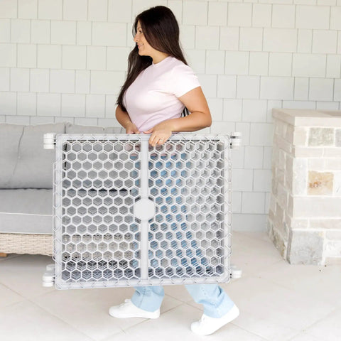 Woman carrying Mega Wide 192 Inch Baby Gate And Play Yard 2 In 1 Gate To Playpen Expands For Open Spaces Great For Babies Toddlers And Pets