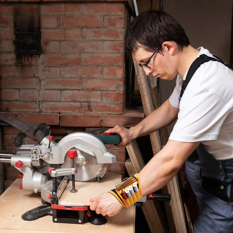 Man using saw wearing Magnetic Wristband For Tools With 9 Neodymium Magnets Holds Screws Nails Drill Bits And Small Tools