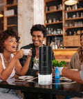 Lightning Fast Portable Electric Coffee Grinder With Smooth Ceramic Burr And 38 Adjustable Grind Settings in a lively café setting.