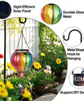 Two Pack Hot Air Balloon Solar Lanterns With Metal Shepherds Hook For Outdoor Pathway Lighting Garden Decor And Cozy Flickering Flame Glow That Charges By Day And Shines At Night, showing colorful balloon and flowers
