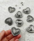 Kick Up Your Craft Game With Heart Shaped Rivets Screw Back Zinc Alloy Studs Solid Silver Metal Conchos For Leather Belts Bags DIY Projects Legit Dope Vibe, silver heart rivets in hand.