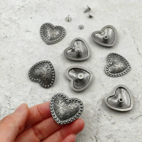 Kick Up Your Craft Game With Heart Shaped Rivets Screw Back Zinc Alloy Studs Solid Silver Metal Conchos For Leather Belts Bags DIY Projects Legit Dope Vibe, silver heart rivets in hand.
