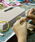 Hand working with Two Piece Honeycomb Ceramic Soldering Board Set For Jewelry Making, heat resistant up to 2000 degrees.