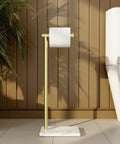 Gold Marble Base Free Standing Toilet Paper Holder Built To Last SUS304 Stainless Steel Bathroom Stand No Tip Design For Humid Bathrooms Rust Resistant Modern Farmhouse Style, displayed in a bathroom setting against a wooden panel wall.
